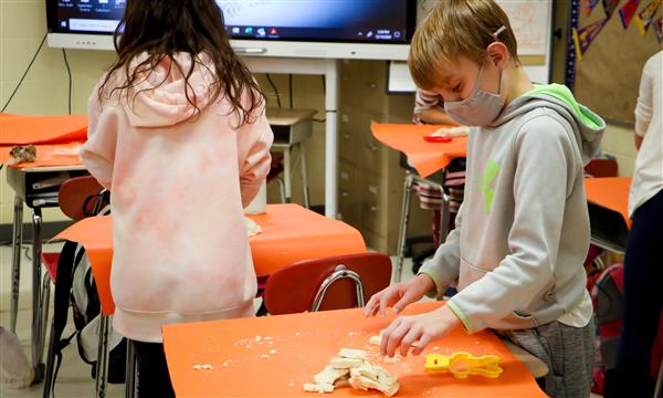 Boy cuts out shape from salt dough